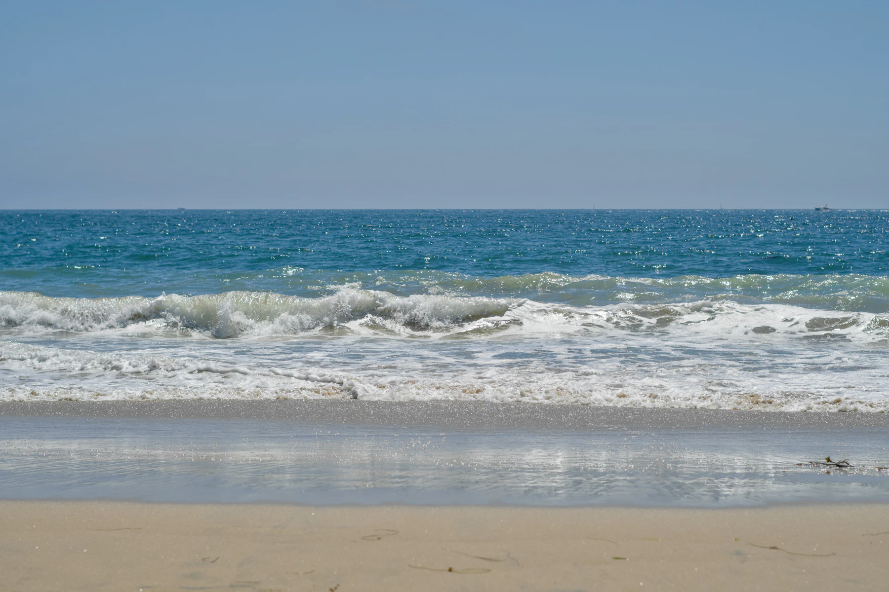 Pacific waves reaching the sand at Newport Beach