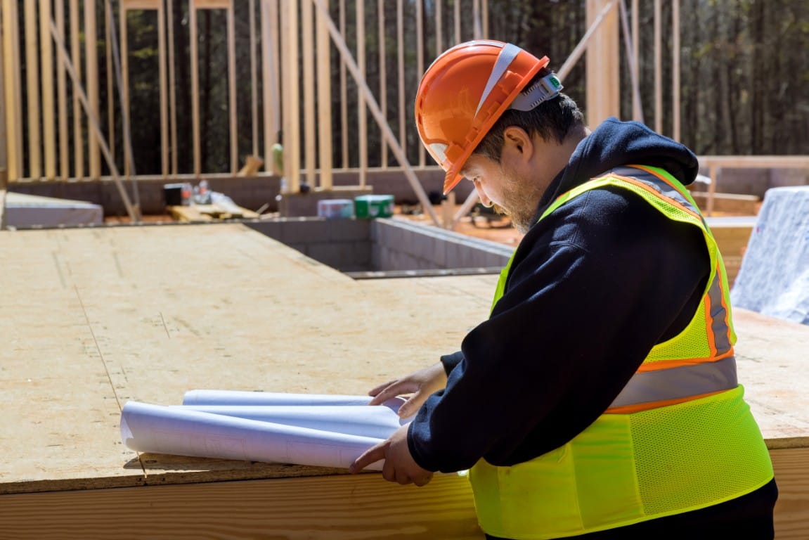 Contractor performing a quality check on completed construction work