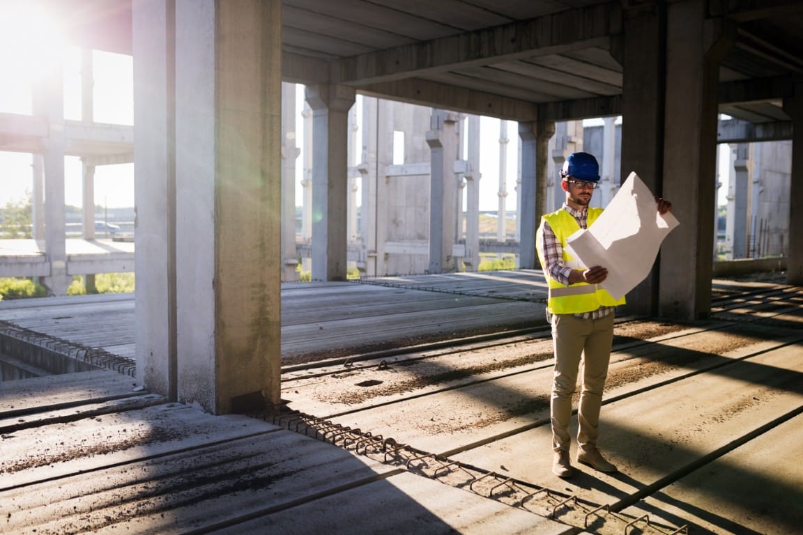 Contractor inspecting a job site for quality and safety compliance