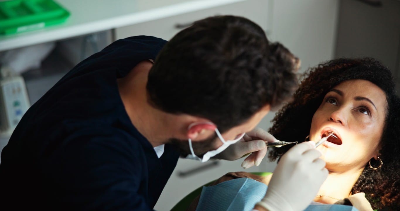 Close-up of a dental mirror examination during a routine checkup