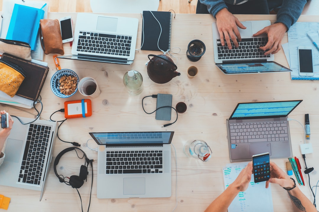dental seo cost — people sitting down near table with assorted laptop computers