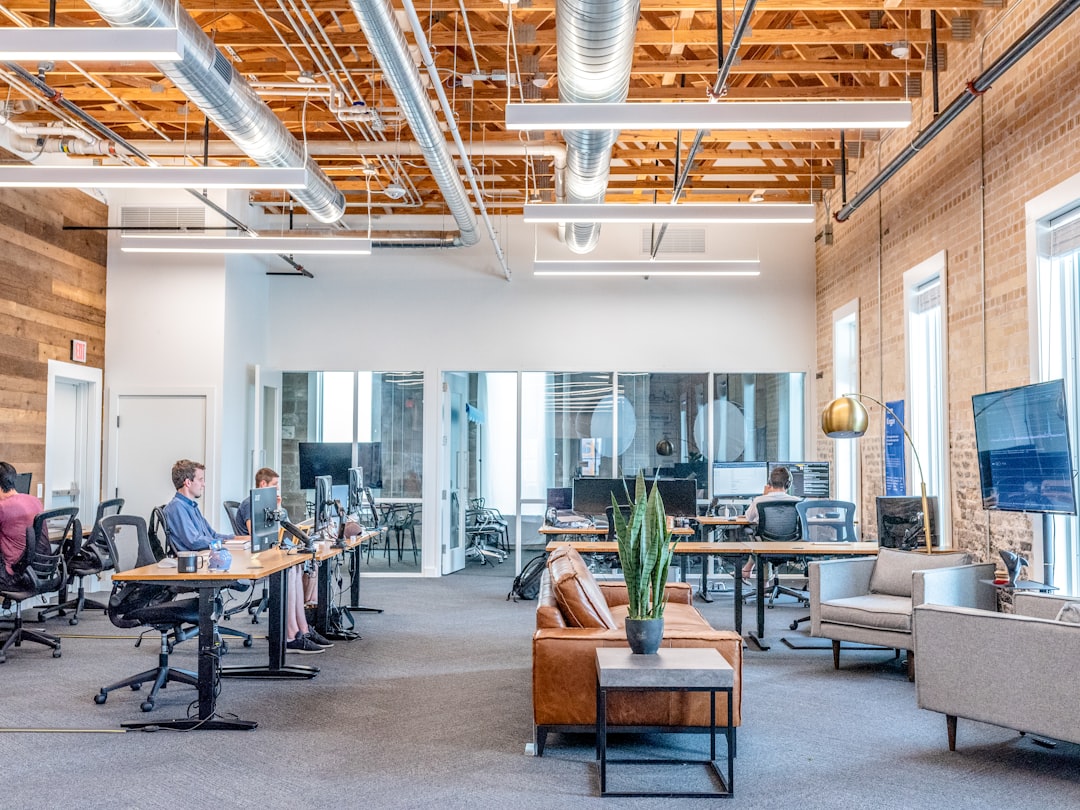 fullerton seo company — man in blue dress shirt sitting on rolling chair inside room with monitors
