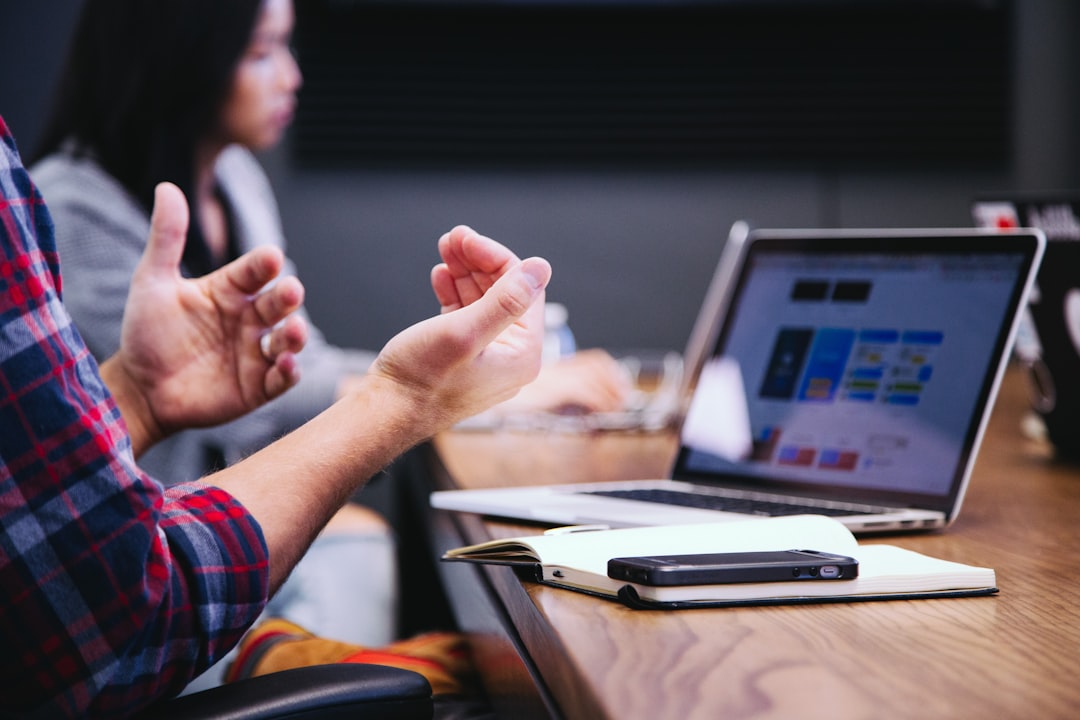hvac marketing agency — person gesturing during meeting with laptop