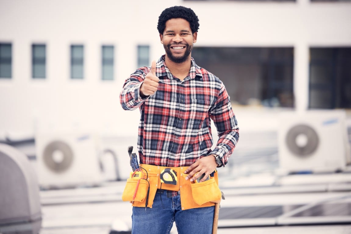 Friendly HVAC worker giving a thumbs up after completing a repair