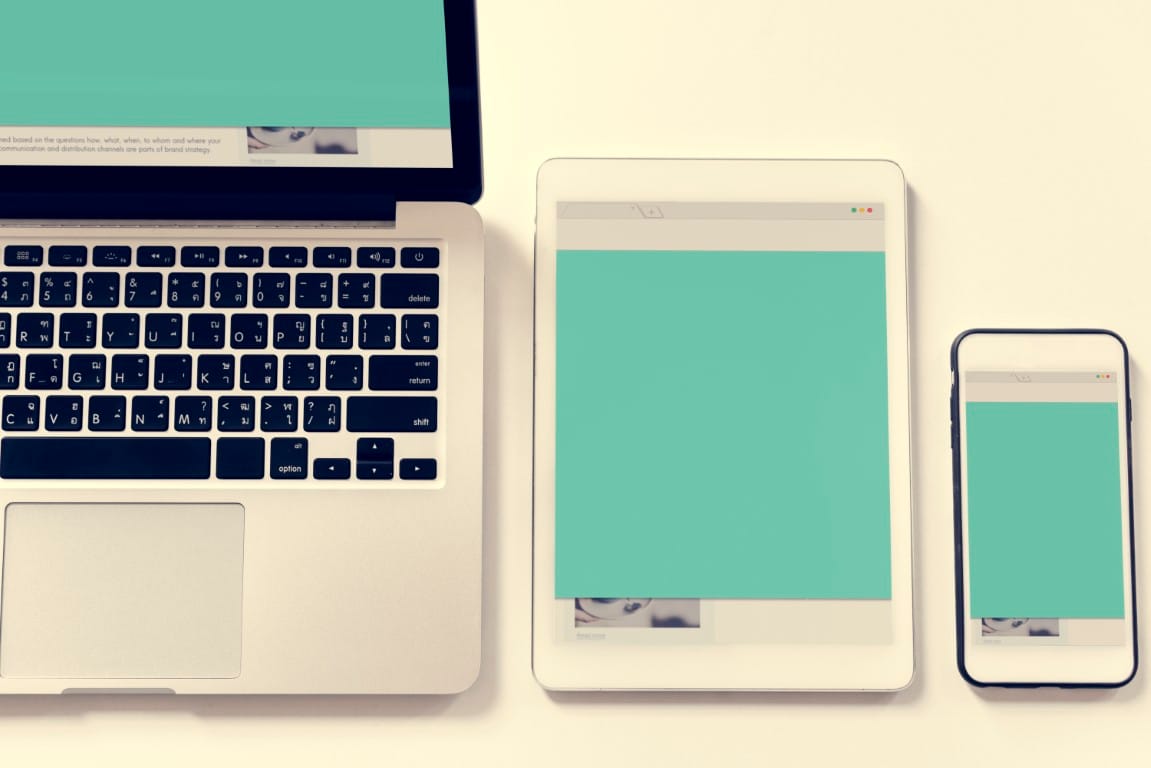 Responsive website design displayed across multiple devices on a desk