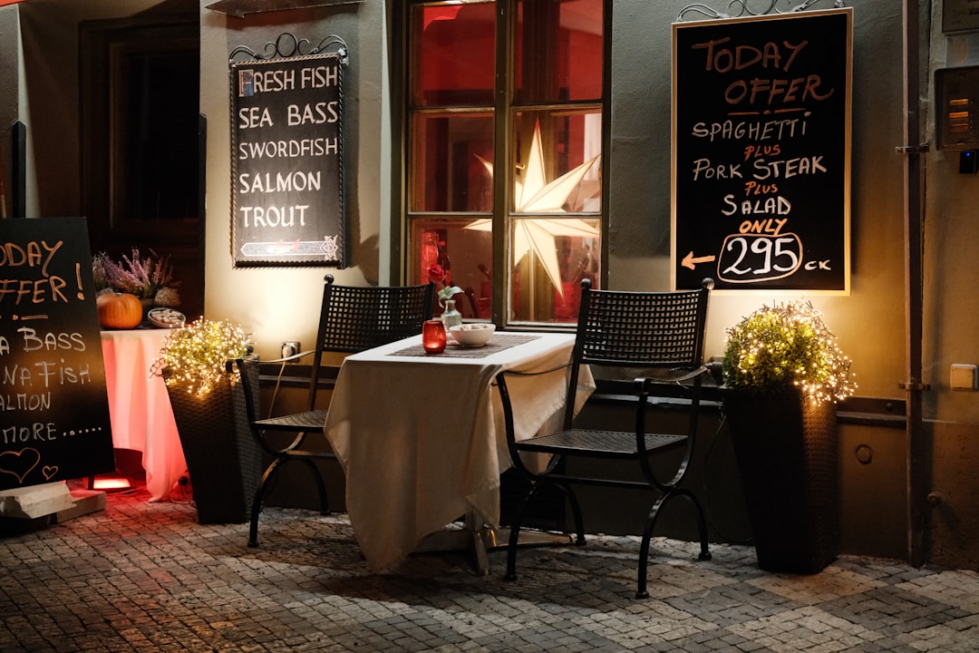 restaurant marketing agency — Restaurant table set outside at night with menus.
