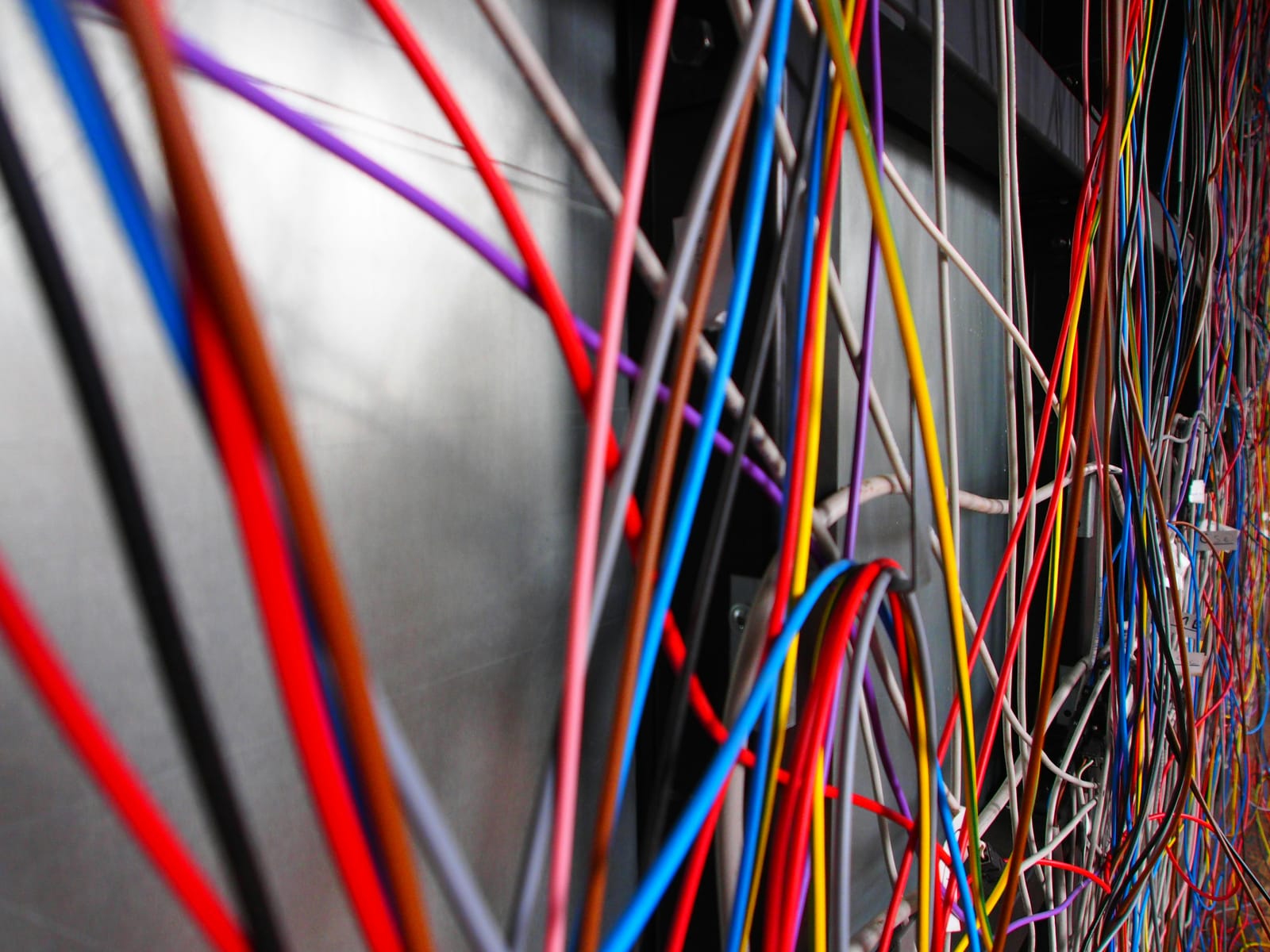 A close-up of tangled, disconnected wires — marketing channels that don’t connect to each other