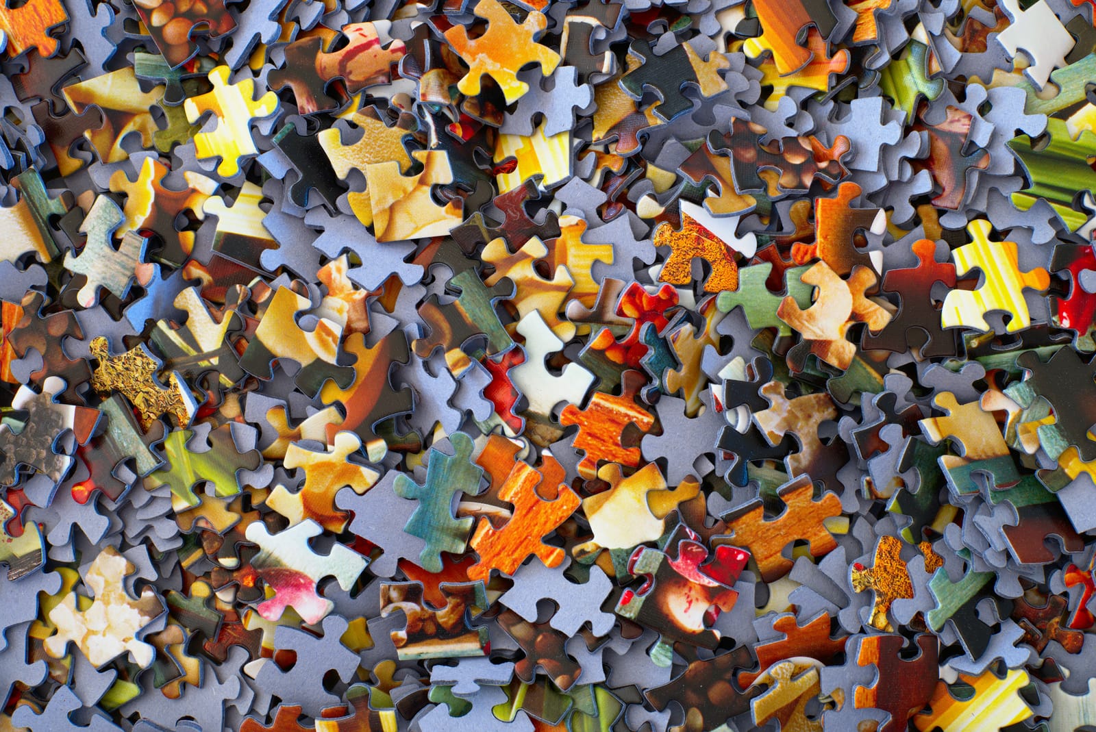 Jigsaw puzzle pieces fitting together — marketing channels aligned around one coordinated strategy