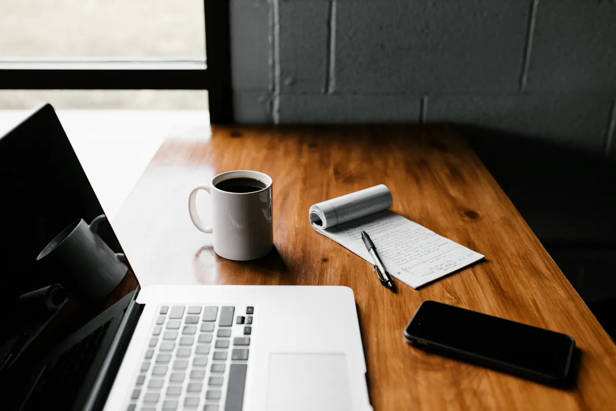 Desk with marketing notes and laptop used for digital marketing research