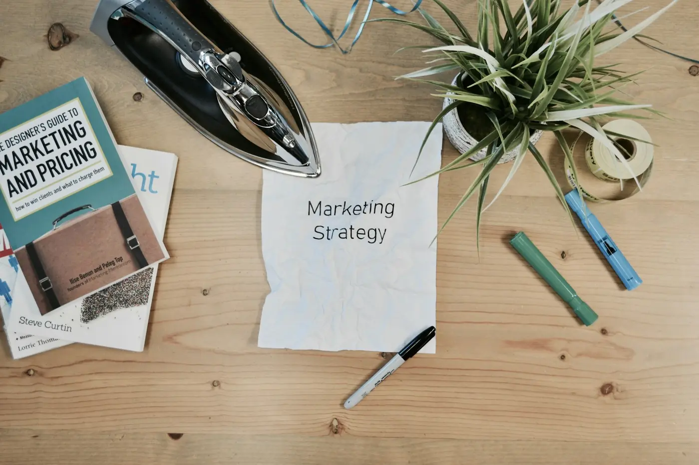 A marketing strategy document with a pen and desk accessories